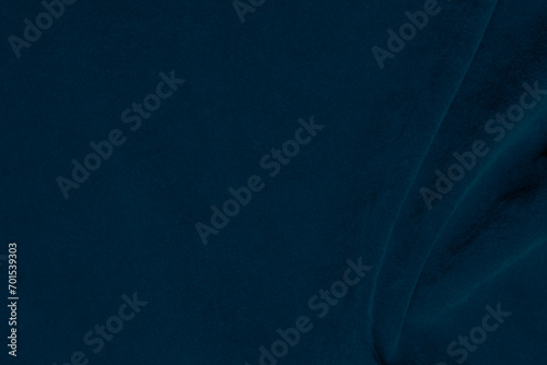 Dark blue velvet fabric texture used as background. silk color denim fabric background of soft and smooth textile material. crushed velvet .luxury navy blue dark tone for silk.