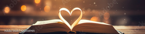 Love story book with open page of literature in heart shape and stack piles of textbooks on reading desk in library, school study room for national library lovers month and education learning concept
