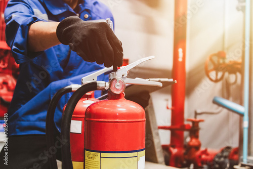 Engineer check fire suppression system,check fire extinguisher tank in the fire control room for safety