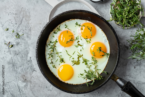 egg breakfast. Fried eggs in a frying pan sprinkled with herbs. fresh breakfast concept