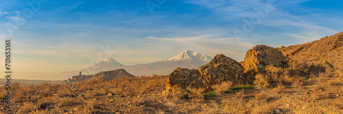 Wide angle panoramic view of close-up of Ararat mountains with the Khor Virap monastery at fall sunrise. Travel destination Armenia
