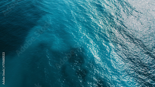 A calm, crystal clear ocean surface with subtle shades of blue creating a serene and minimalist background. Aerial view, Landscapes illustration, Generative AI 