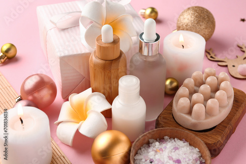 Composition with spa accessories, Christmas decorations and gift box on pink background