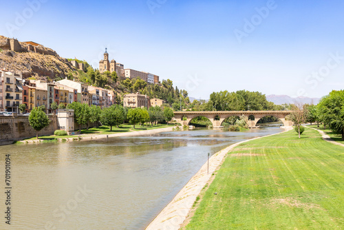 Sant Miquel old bridge over Segre river and a view to the Sant Crist in Balaguer, comarca of Noguera, Province of Lleida, Catalonia, Spain
