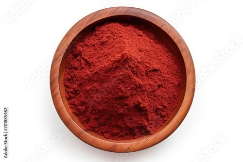 Red sumac powder arranged in a flat lay view on a wood plate isolated on a white background A pile of isolated sumac powder