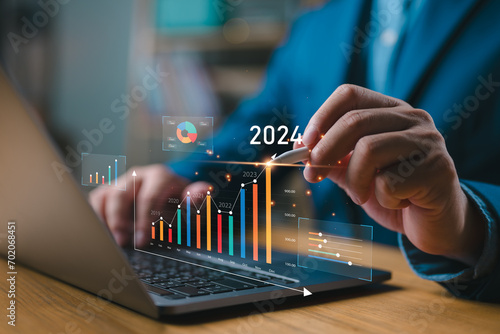 Businessman investor analyzes profitability of working companies with digital augmented reality graphics, positive indicators in 2024, businessman calculates financial data for long-term investments.