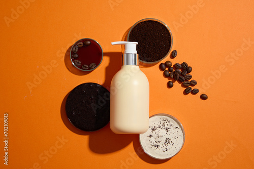 Concept for advertising product for body care with natural ingredient. A pump bottle displayed with petri dishes filled of coffee beans, cream texture and coffee ground on orange background