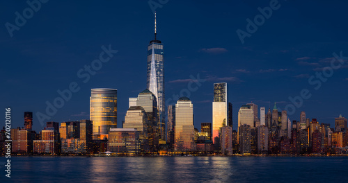 Lower Manhattan skyline at twilight. Last rays of sunset reflecting on World Trade Center skyscrapers. Battery Park, New York City