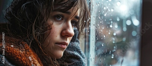 Bored Woman Looking at the Rainy Weather By the Window Frame. with copy space image. Place for adding text or design