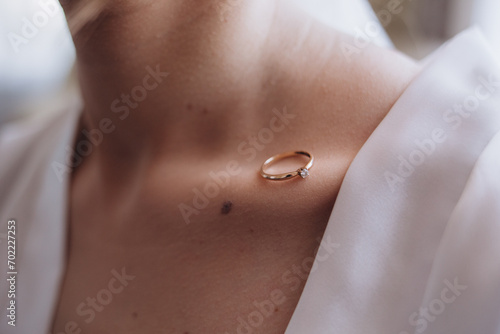 wedding ring on the collarbone of the bride