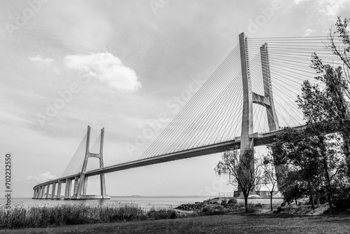 Vasco da Gama bridge in Lisbon, Portugal; cable stayed bridge flanked by viaducts and rangeviews that spans the Tagus river in Parque das Nacoes, the second longest bridge in Europe in black and white