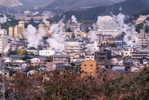 Beppu cityscape with Steam drifted from public hot spring baths and ryokan onsen background, Beppu, Oita, Kyushu, Japan.