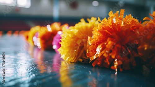 Colorful cheerleading pom-poms on a gym floor
