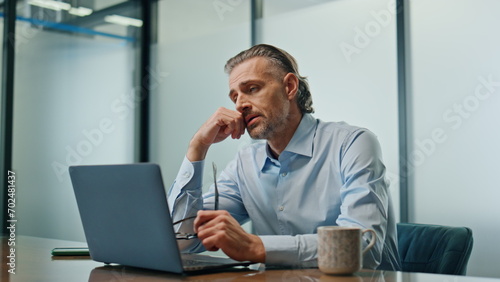 Worried ceo sitting workplace closeup. Stressed businessman getting bad news