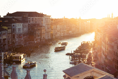 A charming sunset from the top of the Rialto Bridge, looking towards the Grand Canal in Venice, Italy
