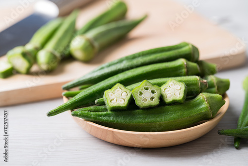 Green okra in wooden bowl prepare for cooking, Organic vegetables