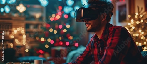 Arab male blogger reviewing VR Glasses, recording video for his tech blog at home on Christmas. Banner.