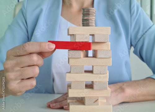 Jenga affects pile of coins falling and losing money