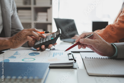 Calculate the numbers according to the report sent to the meeting, They are calculating the taxes they have to pay, They are having a meeting about the company's income and expenses,