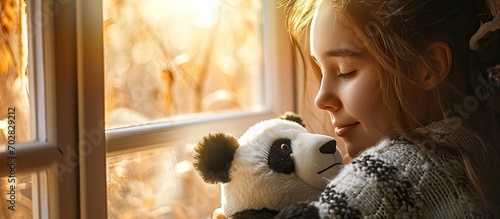 Happy woman smelling her freshly washed panda plush she just took it out from the washing machine. with copy space image. Place for adding text or design