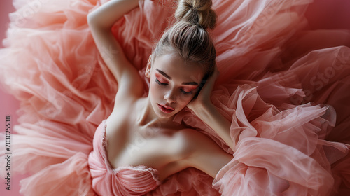 Beautiful ballet dancer in delicate, pink dress, resting after ballet performance. A Ballerina's Quiet Moment.