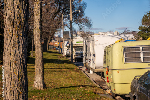 housing crisis: older travel trailers being lived in on a public street in an industrial section of a big north american city (toronto).
