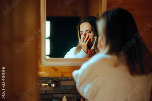 Woman Suffering a Toothache Trying to Brush her Teeth. Unhappy girl feeling in pain from an oral infection and a cavity problem 