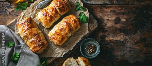 Delicious sausage rolls on a rustic table, above view, copy space.