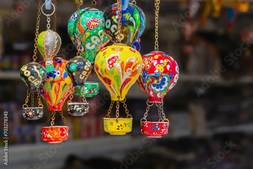 Hot air balloons. Handmade ceramics souvenirs in form of flying multicolored balloons in gift shop in Goreme. Typical souvenir or gift from Cappadocia, Turkey (Turkiye)