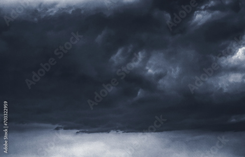 Dark storm clouds with paper texture style. The overcast sky backdrop. The atmosphere is somber. Extreme weather and climate change. Moody and gloomy.