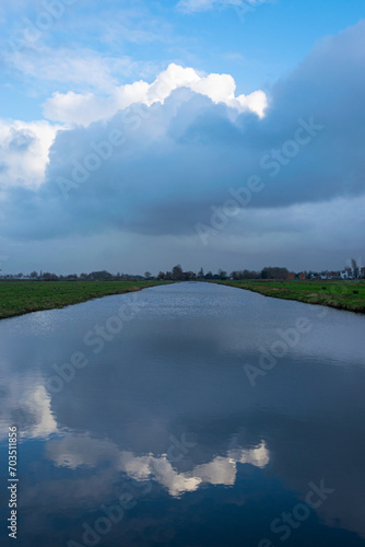 Tranquil view of clouds which are reflected in the calm waters of the Dutch polder landscape