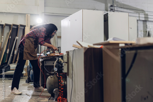 Carpenter working on woodworking machines in carpentry shop. Carpenter working to making wood furniture in wood workshop