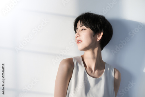Beauty close-up of a cool woman with short black hair and ennui expression posing Dazzling