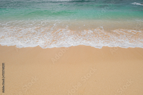 Blue ocean waves on sandy beach