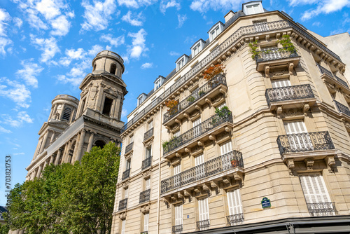 Glimpse of a typical and elegant residential building near place Saint Sulpice in Paris city center, France, with wrought iron railings and balconies 