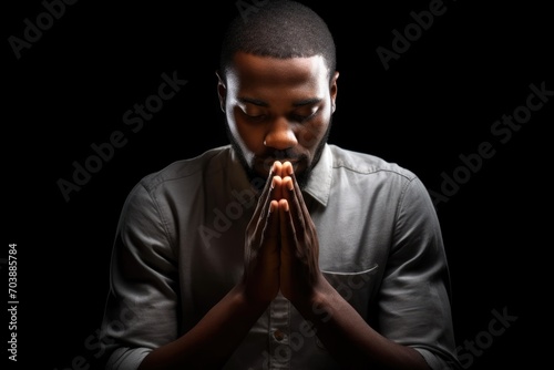 african american man praying on black background, praying to god with religious