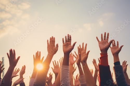 People of different ethnicities raising their hands in the air