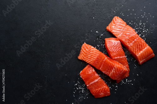 Raw fresh organic trout fillet with ingredients for cooking. Top view with copy space.