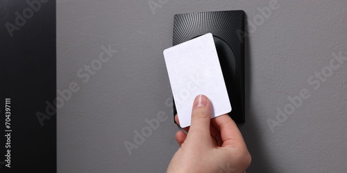 Woman opening magnetic door lock with key card, closeup and space for text. Home security