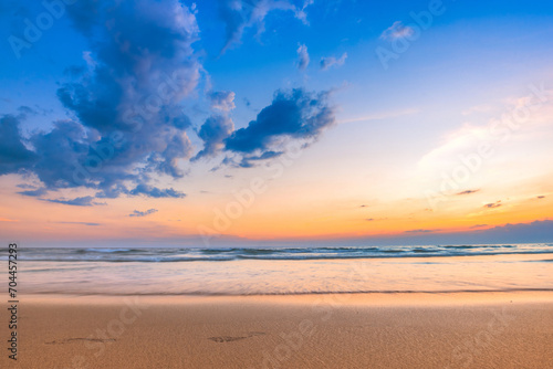 Calm seascape with a beautiful sunset sky and fluffy clouds.