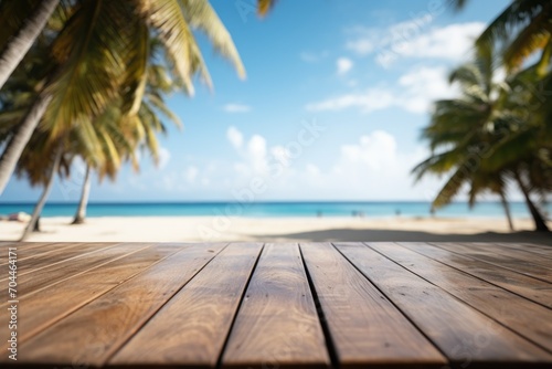 Summer tropical sea beach with waves, palm leaves and blue sky with clouds. Vacation landscape with empty wooden table for display of presentation product