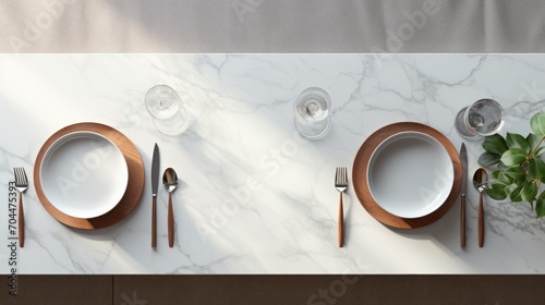 Top view of marble dinning table with white ceramic plates on placemat,