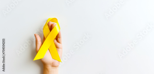 yellow Ribbon against white background for endometriosis awareness campaign, suicide prevention , a Childhood cancer.