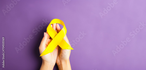 yellow Ribbon against white background for endometriosis awareness campaign, suicide prevention , Childhood cancer.