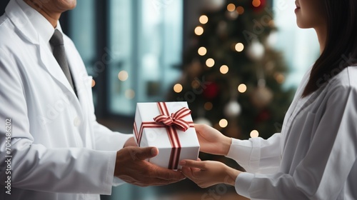 Doctor and nurse exchanging gifts during Christmas