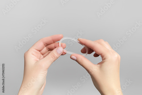 female hands holding hormonal contraceptive ring