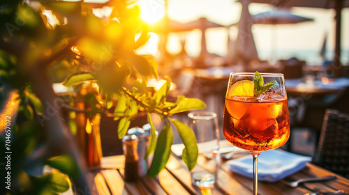 Aperol Spritz cocktail server on cafe patio, summer sunset