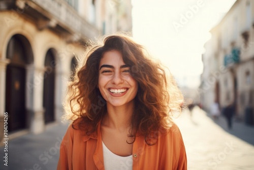 Italian girl with a beautiful smile on the street in summer