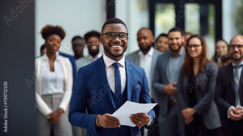 African young business man in front of a group