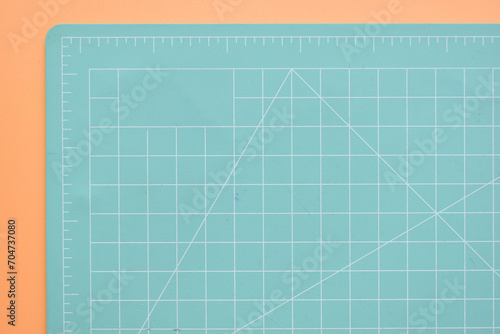 green cutting mat on orange background, object tool for design